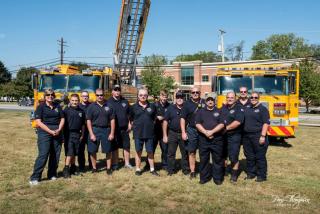 A group of people next to a fire truck